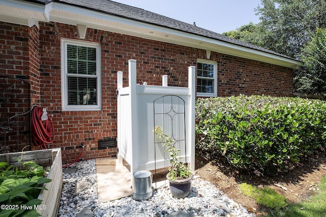 4301 Gainesford Ct, Wilmington, NC 28412 - view of exterior entry featuring brick siding and a shingled roof