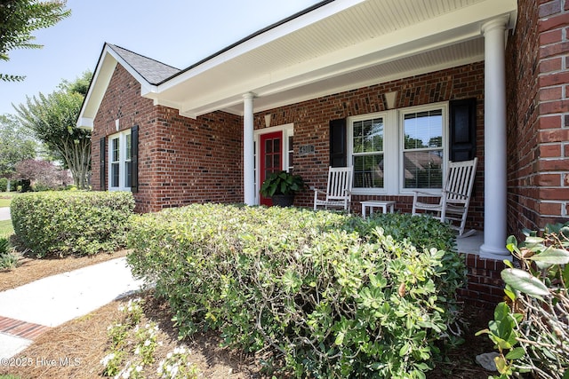 4301 Gainesford Ct, Wilmington, NC 28412 - doorway to property with brick siding and a porch