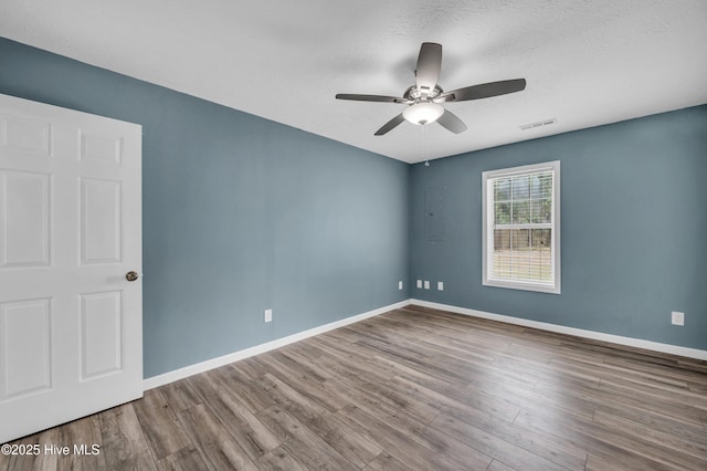 711 Navaho Trl, Wilmington, NC 28409 - spare room with a ceiling fan, wood finished floors, and a textured ceiling