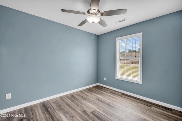 711 Navaho Trl, Wilmington, NC 28409 - empty room with a ceiling fan and wood finished floors