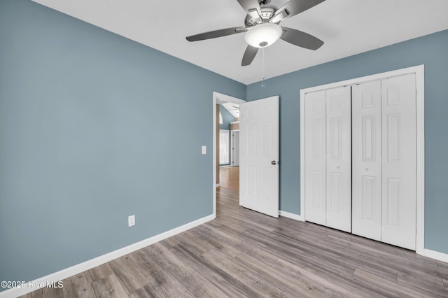 711 Navaho Trl, Wilmington, NC 28409 - unfurnished bedroom with wood finished floors, a closet, and a ceiling fan