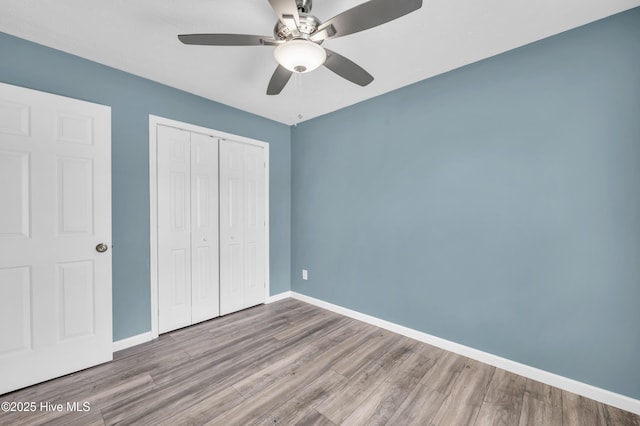 711 Navaho Trl, Wilmington, NC 28409 - unfurnished bedroom featuring wood finished floors, a closet, and ceiling fan