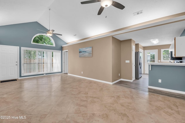 711 Navaho Trl, Wilmington, NC 28409 - unfurnished living room featuring ceiling fan, light tile patterned floors, and high vaulted ceiling