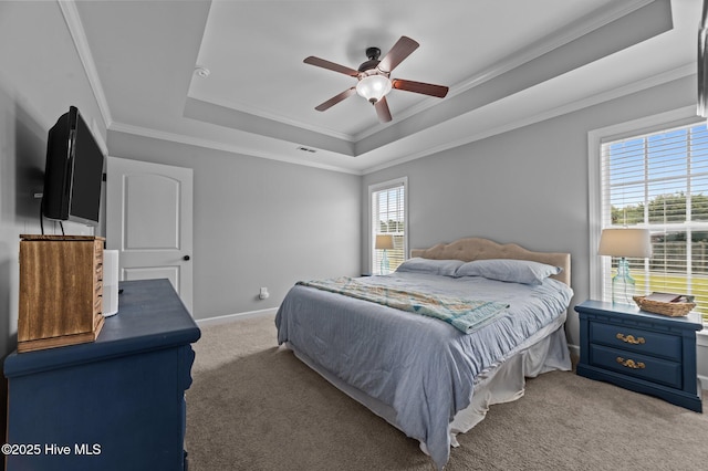 1763 Oak Pointe Dr, Greenville, NC 27834 - carpeted bedroom with a raised ceiling, crown molding, ceiling fan, and baseboards