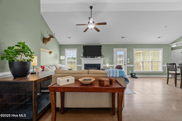 1763 Oak Pointe Dr, Greenville, NC 27834 - living room featuring ceiling fan, lofted ceiling, a fireplace, baseboards, and wood finished floors