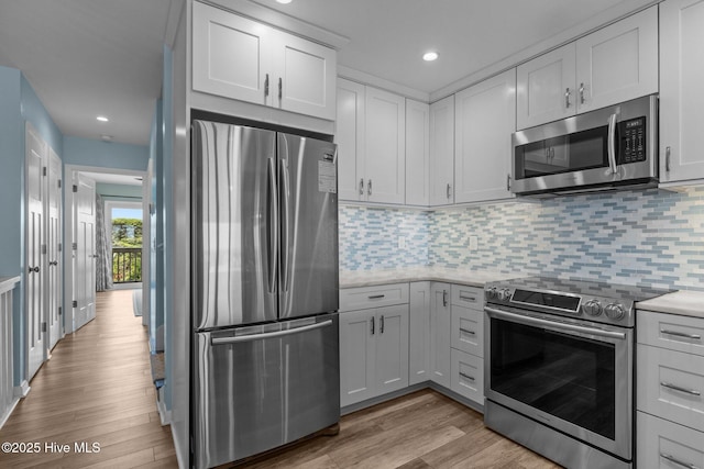535 Salter Path Rd Unit 3, Pine Knoll Shores, NC 28512 - kitchen with stainless steel appliances, light wood-style floors, backsplash, recessed lighting, and light stone counters
