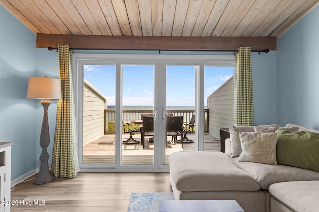 535 Salter Path Rd Unit 3, Pine Knoll Shores, NC 28512 - living area with healthy amount of natural light, wood finished floors, baseboards, and wood ceiling with exposed beams