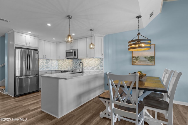 535 Salter Path Rd Unit 3, Pine Knoll Shores, NC 28512 - kitchen with appliances with stainless steel finishes, a sink, a peninsula, white cabinets, and recessed lighting