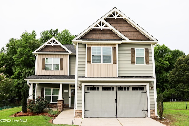 103 Stafford Dr, Pikeville, NC 27863 - craftsman inspired home with an attached garage, driveway, board and batten siding, a porch, and stone siding