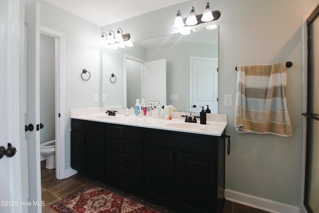 103 Stafford Dr, Pikeville, NC 27863 - bathroom featuring double vanity, toilet, and tile patterned flooring