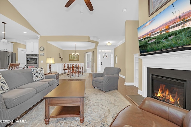 4277 Kingston Ct, Southport, NC 28461 - living area featuring a glass covered fireplace, crown molding, ceiling fan, a chandelier, and recessed lighting