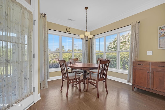 4277 Kingston Ct, Southport, NC 28461 - dining space with plenty of natural light, a chandelier, baseboards, dark wood-style flooring, and crown molding