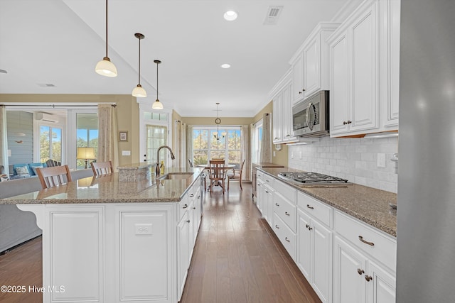 4277 Kingston Ct, Southport, NC 28461 - kitchen featuring a sink, appliances with stainless steel finishes, healthy amount of natural light, a kitchen breakfast bar, and crown molding