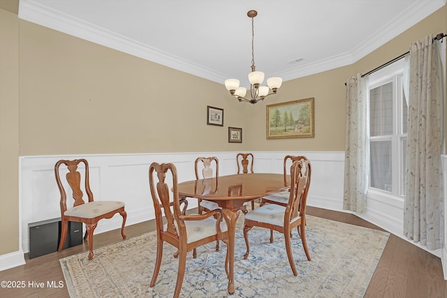 4277 Kingston Ct, Southport, NC 28461 - dining room featuring a chandelier, ornamental molding, wainscoting, and wood finished floors