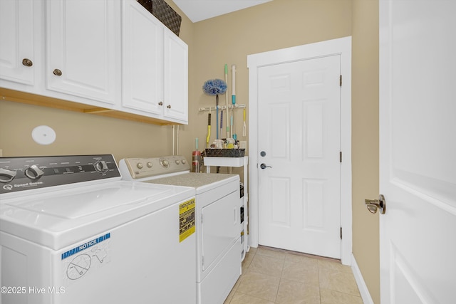 4277 Kingston Ct, Southport, NC 28461 - washroom featuring washer and clothes dryer, cabinet space, light tile patterned floors, and baseboards
