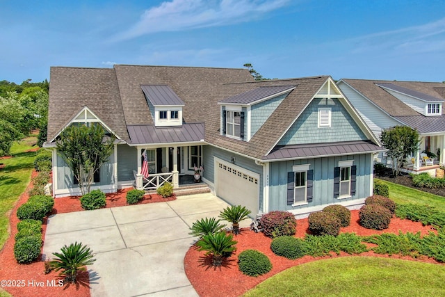 4277 Kingston Ct, Southport, NC 28461 - view of front of home with covered porch, board and batten siding, a standing seam roof, and an attached garage