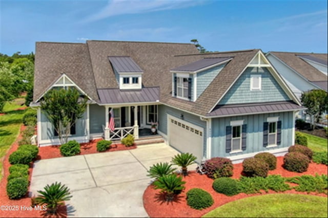 4277 Kingston Ct, Southport, NC 28461 - view of front of property with a porch, an attached garage, concrete driveway, board and batten siding, and metal roof