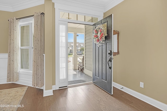 4277 Kingston Ct, Southport, NC 28461 - entryway with crown molding, wood finished floors, ornate columns, and baseboards