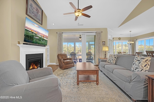 4277 Kingston Ct, Southport, NC 28461 - living area featuring lofted ceiling, ceiling fan, wood finished floors, a lit fireplace, and french doors