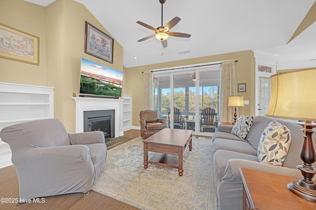 4277 Kingston Ct, Southport, NC 28461 - living room with a ceiling fan, lofted ceiling, a fireplace, and wood finished floors