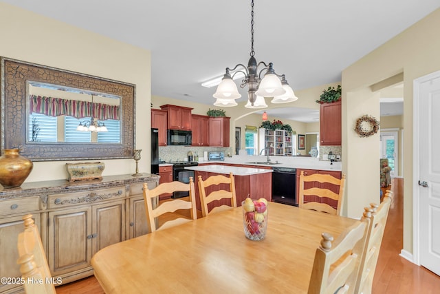 5170 Swashbuckler Way, Southport, NC 28461 - dining area featuring a chandelier and light wood-type flooring
