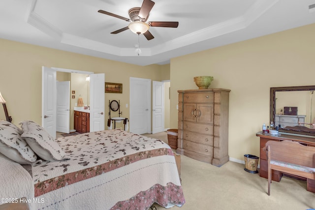 5170 Swashbuckler Way, Southport, NC 28461 - bedroom with a tray ceiling, light carpet, ornamental molding, ensuite bathroom, and a ceiling fan