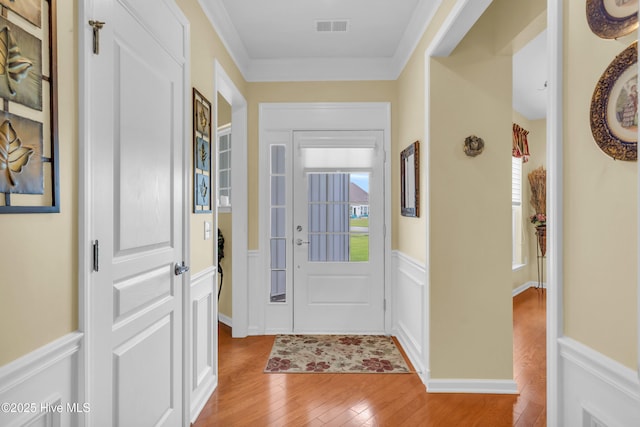 5170 Swashbuckler Way, Southport, NC 28461 - foyer entrance featuring light wood-style floors, wainscoting, and crown molding