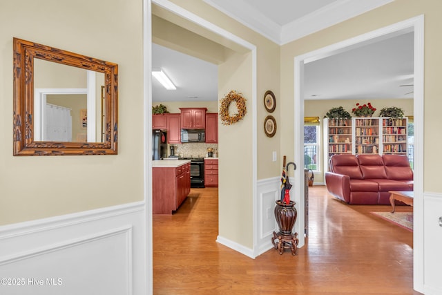 5170 Swashbuckler Way, Southport, NC 28461 - hall with light wood-style floors, wainscoting, and crown molding