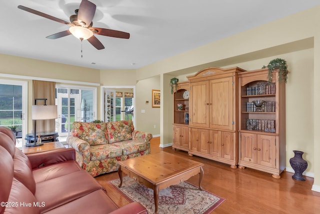5170 Swashbuckler Way, Southport, NC 28461 - living room featuring wood finished floors, a ceiling fan, and baseboards