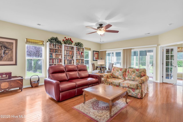 5170 Swashbuckler Way, Southport, NC 28461 - living room featuring ceiling fan, light wood-style floors, healthy amount of natural light, and baseboards
