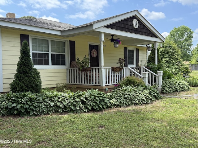 9439 Clayton Blvd, Clayton, NC 27520 - view of front of property with a front yard, a chimney, a porch, and ceiling fan
