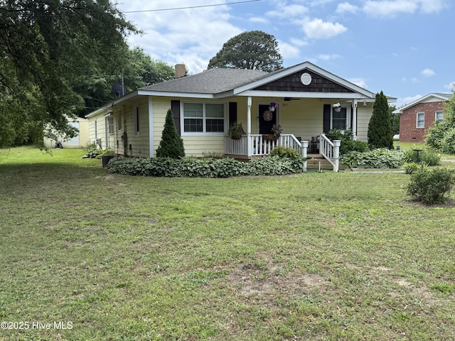 9439 Clayton Blvd, Clayton, NC 27520 - view of front facade with covered porch, a chimney, and a front lawn