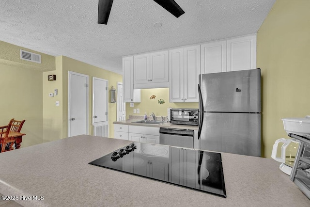 404 S Carolina Beach Ave Unit B7, Carolina Beach, NC 28428 - kitchen with black appliances, white cabinets, a ceiling fan, a textured ceiling, and light countertops