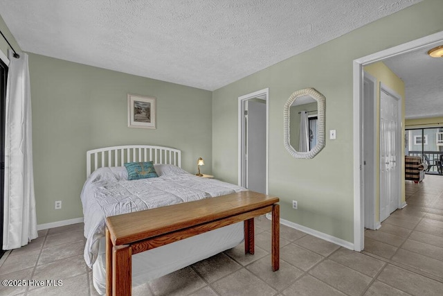 404 S Carolina Beach Ave Unit B7, Carolina Beach, NC 28428 - bedroom featuring a textured ceiling and light tile patterned floors