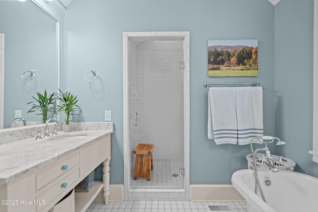401 Fire Fly Ln, Southport, NC 28461 - bathroom with a stall shower, a freestanding tub, vanity, baseboards, and tile patterned flooring