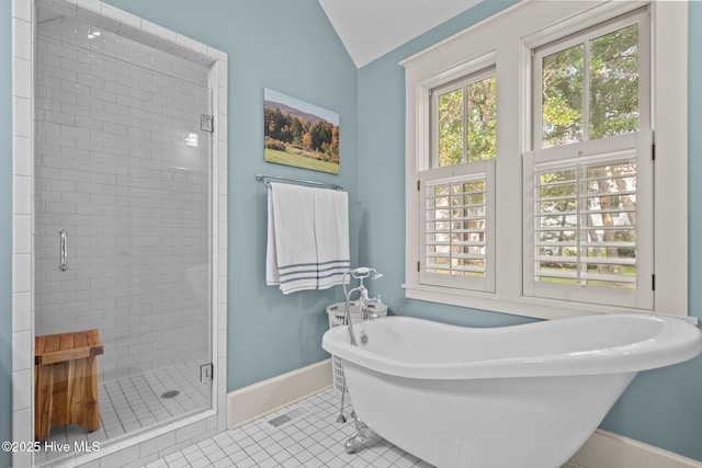 401 Fire Fly Ln, Southport, NC 28461 - full bath featuring baseboards, a stall shower, tile patterned flooring, a soaking tub, and vaulted ceiling