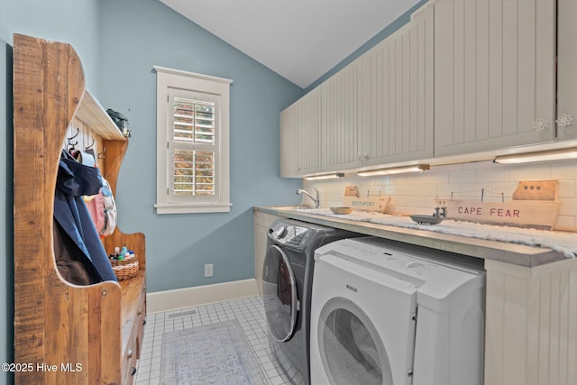 401 Fire Fly Ln, Southport, NC 28461 - washroom with cabinet space, washing machine and clothes dryer, light tile patterned flooring, and baseboards
