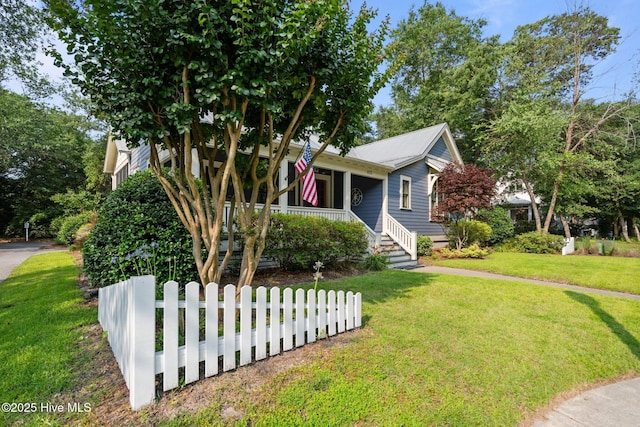 401 Fire Fly Ln, Southport, NC 28461 - view of front of home with covered porch and a front yard