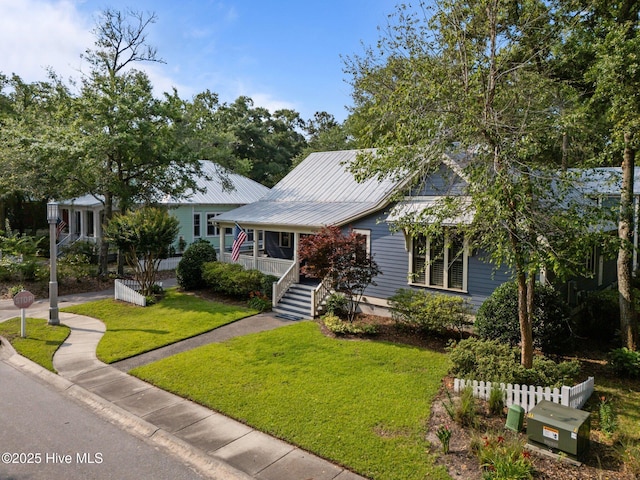 401 Fire Fly Ln, Southport, NC 28461 - view of front of home with metal roof and a porch