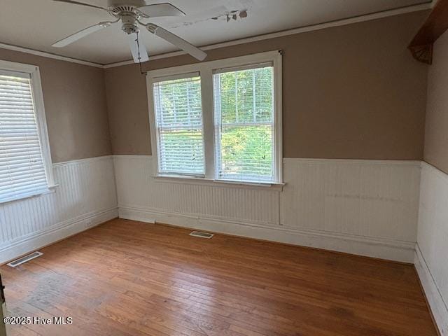1041 Lafayette Ave, Rocky Mount, NC 27803 - spare room featuring ceiling fan, wainscoting, and wood finished floors