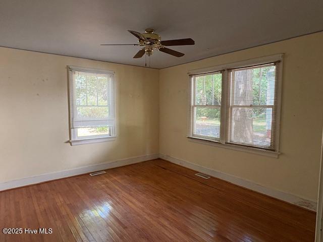 1041 Lafayette Ave, Rocky Mount, NC 27803 - spare room featuring wood finished floors, baseboards, and a ceiling fan