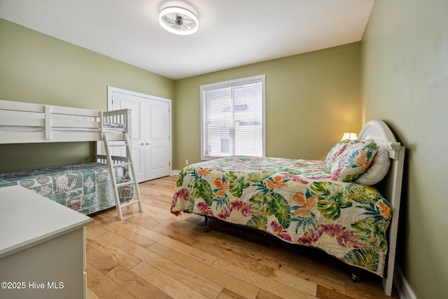 bedroom with light wood-style floors and a closet