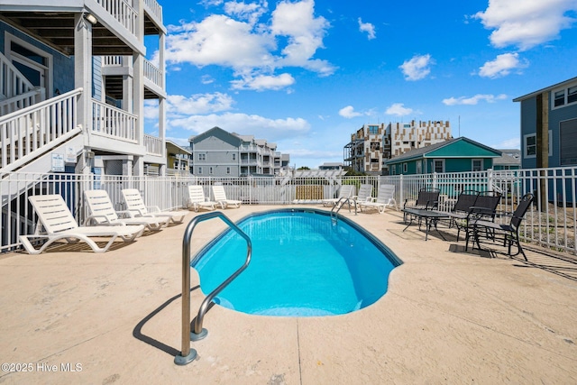 community pool with a patio area