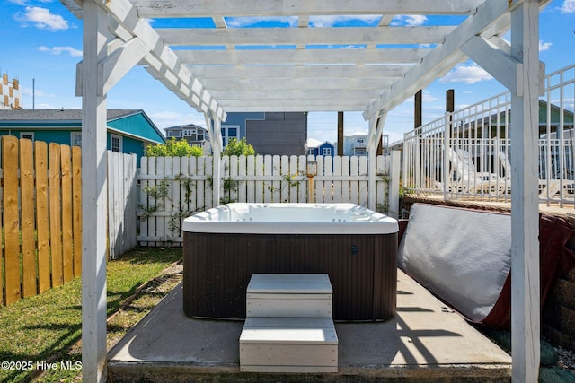 view of patio / terrace featuring a hot tub and a pergola