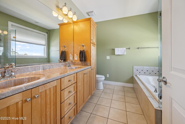 full bath featuring double vanity, a garden tub, and tile patterned flooring