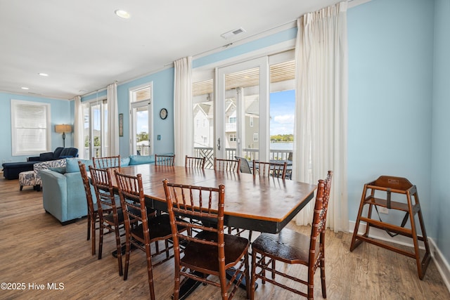 dining area with wood finished floors and recessed lighting