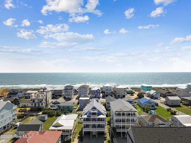 aerial perspective of suburban area with a nearby body of water