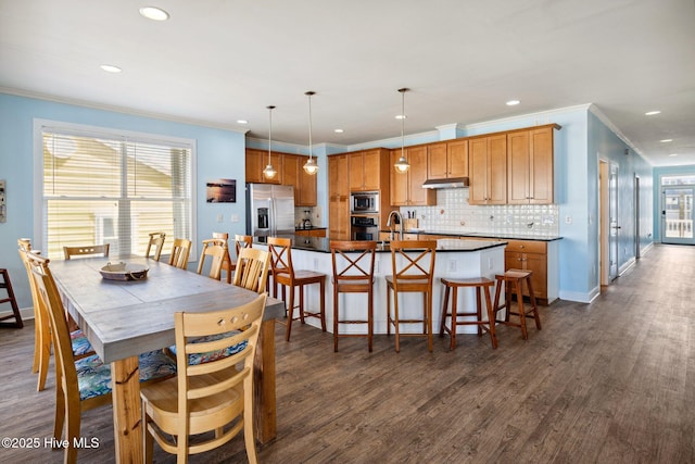 dining space featuring recessed lighting, ornamental molding, and dark wood-style flooring