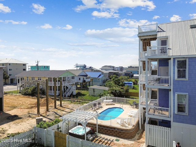 community pool featuring a fenced backyard and a residential view