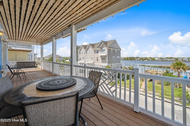 wooden terrace featuring a water view and a residential view